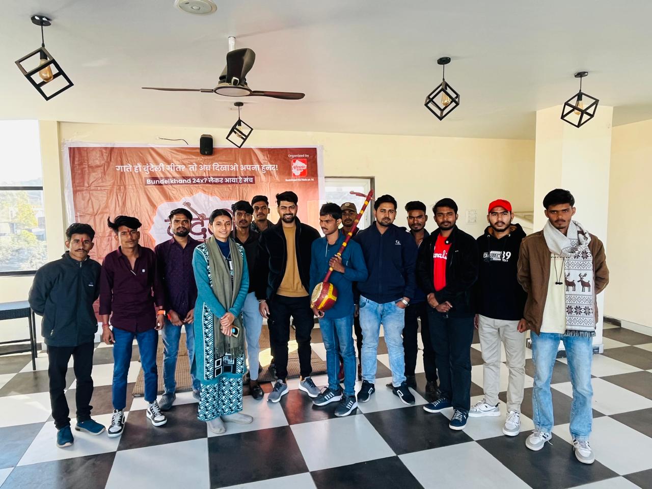 Participants of a Bundeli Bawra cultural event gathered indoors